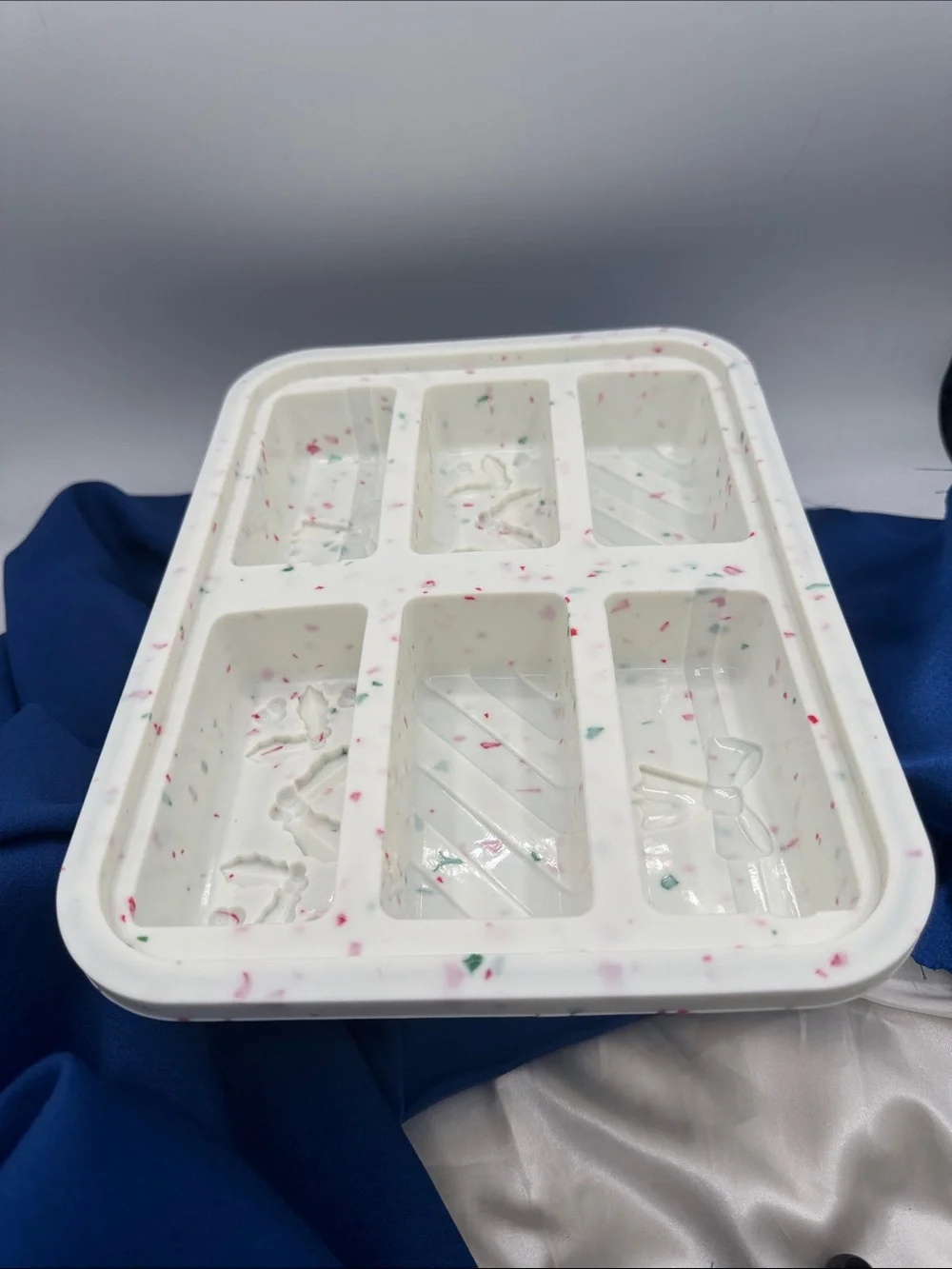 This image shows a holiday-themed silicone snap bar mold being used to create fe